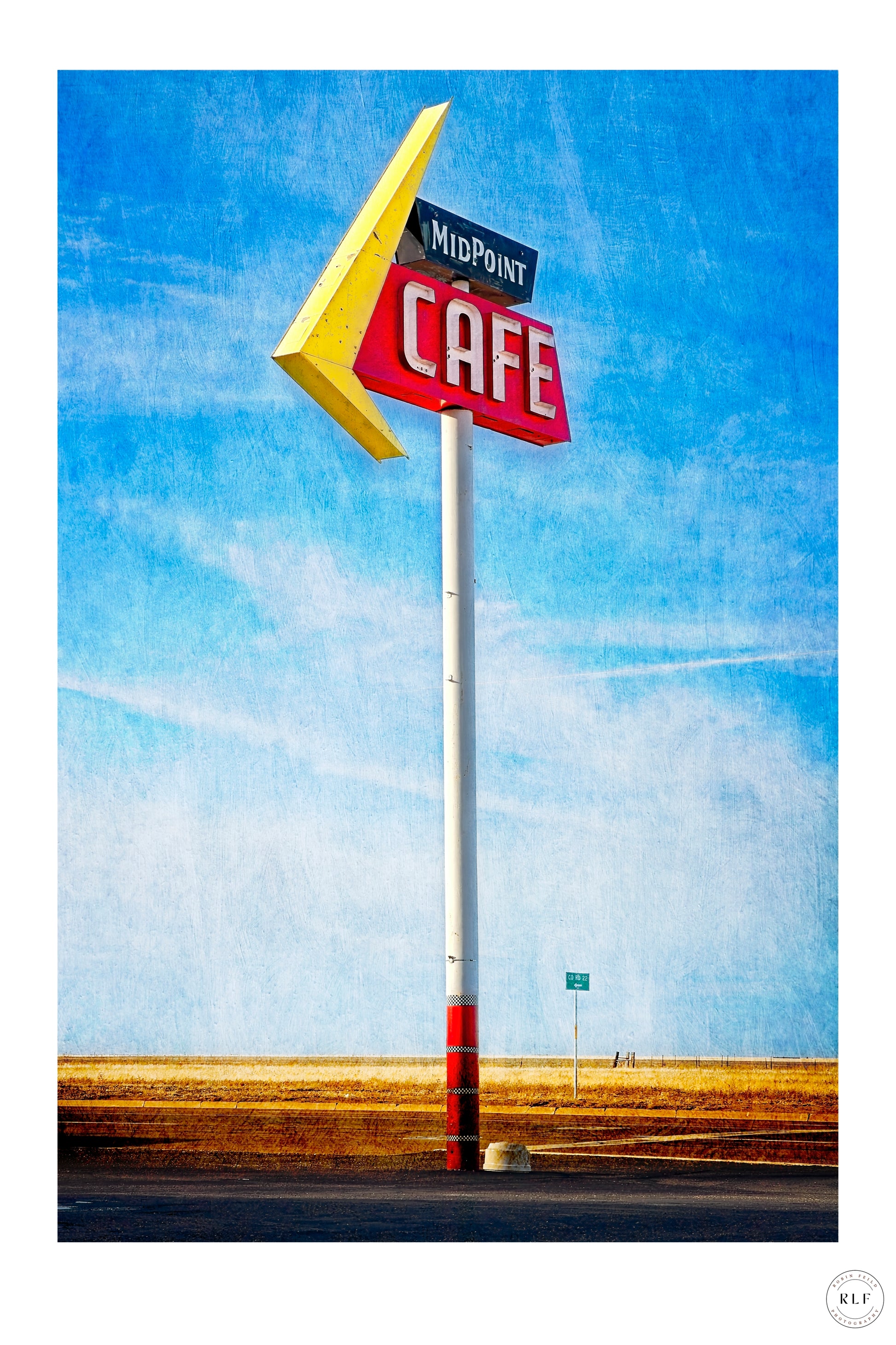 Vintage "Midpoint Cafe" roadside sign with red and yellow details, set against a bright blue sky and open fields. Fine art photography by RLF Photography