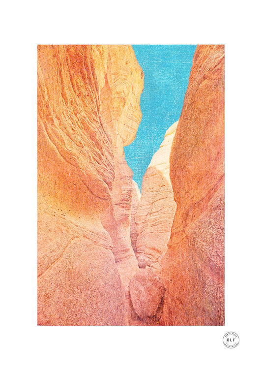 Slot canyon passage with glowing orange rock walls, a wedged boulder and a vivid turquoise sky above, Tent Rocks, New Mexico. Fine art photography by RLF Photography
