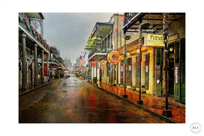 Rain-soaked street in New Orleans with glistening surfaces, colourful buildings, illuminated signs, and wrought-iron balconies. Fine art photography by RLF Photography