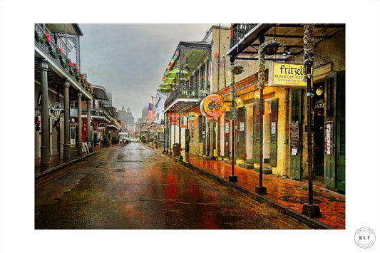 Rain-soaked street in New Orleans with glistening surfaces, colourful buildings, illuminated signs, and wrought-iron balconies. Fine art photography by RLF Photography