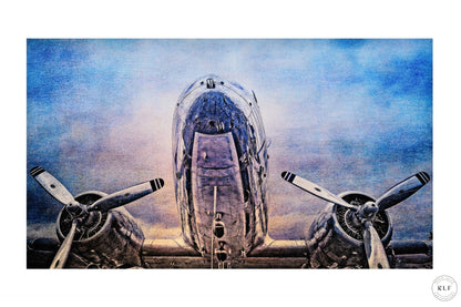 Vintage McDonnell Douglas DC3 vintage aircraft with polished chrome fuselage and propellers, set against a cloudy blue sky. Fine art photography by RLF Photography